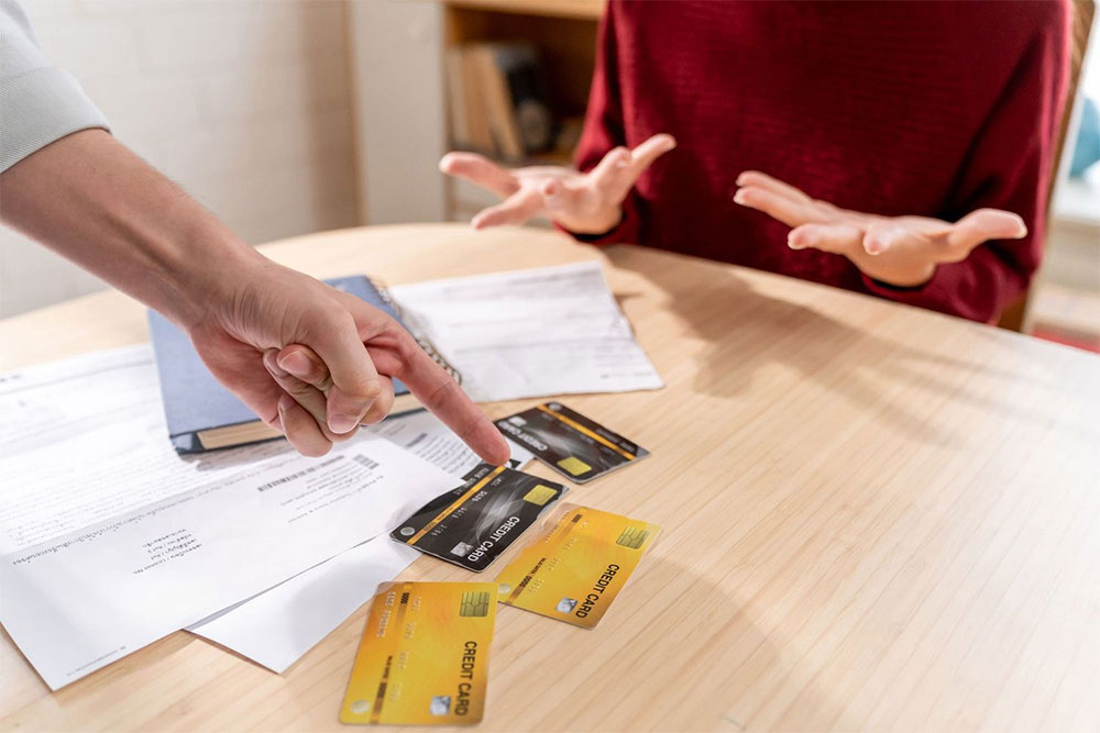 punishing single mothers - a man angrily points to credit cards